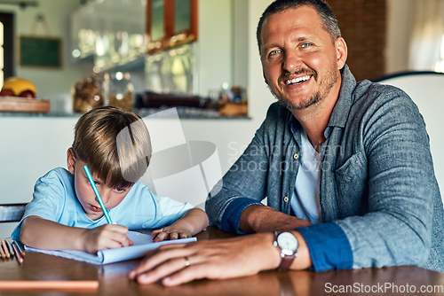 Image of Hes curious to know about everything from A-Z. Shot of a father helping his son with his homework.