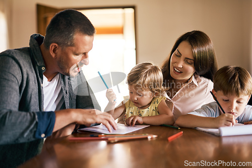 Image of Engaging their kids in creative play. Shot of a young family of four drawing and getting creative together at home.