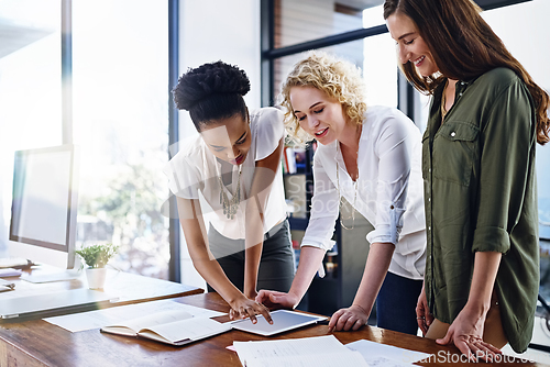 Image of Making vital decisions together to improve their chances at success. Cropped shot of a team of designers working together in the office.