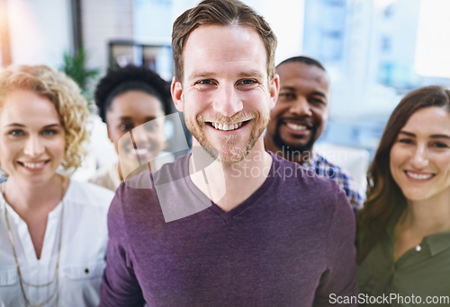 Image of Were definitely a passionate team of creatives. Portrait of a team of designers standing together in the office.