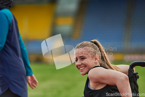 Image of A woman with disablity driving a wheelchair on a track while preparing for the Paralympic Games