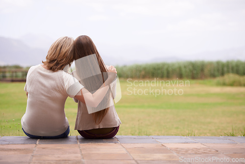 Image of These moments together are so precious. An affectionate mother sitting outside with her adult daughter.