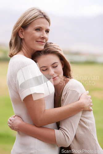 Image of Everyone needs a hug like that once in a while. A mother embracing her daughter.