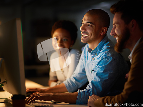 Image of Making easy work of overtime as a team. Cropped shot of a group of colleagues working late in an office.