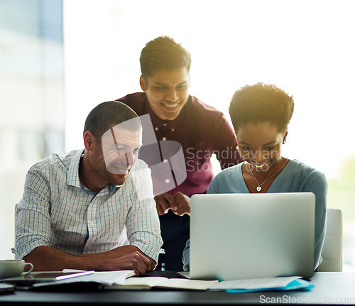 Image of Working together to get ahead. Cropped shot of a group of colleagues working together on a laptop in an office.