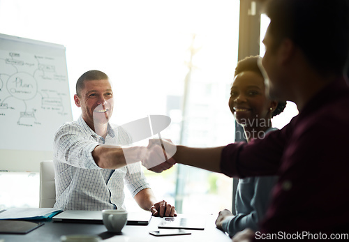 Image of Our skills together will make for a winning combination. Cropped shot of businesspeople shaking hands during a meeting in an office.