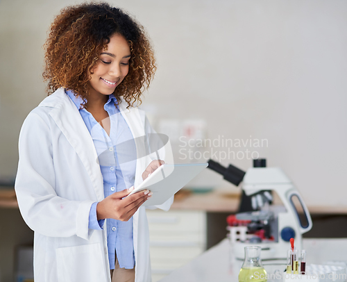 Image of Recording the results. Cropped shot of an attractive young woman capturing data on her tablet in the lab.