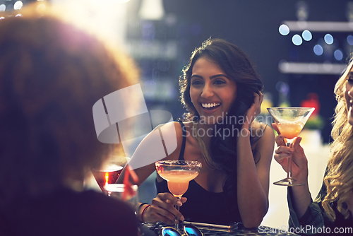 Image of Is it time for another round yet. Shot of a group of friends relaxing with cocktails in a nightclub.