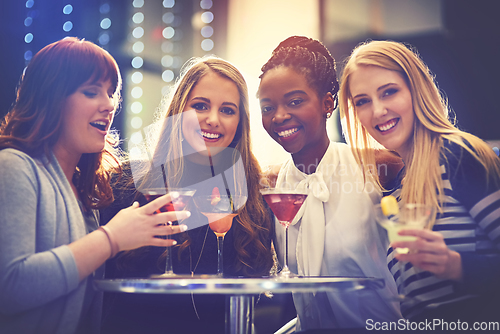 Image of All you need are good friends and fruity drinks. Portrait of a group of happy friends enjoying cocktails in a nightclub.