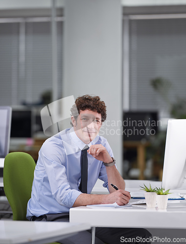 Image of Hes a ver diligent worker. Cropped shot of a young businessman sitting at his desk.