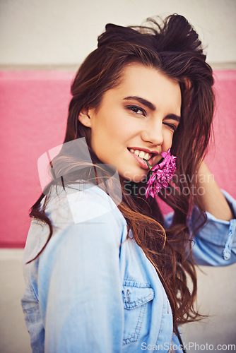 Image of There are so many beautiful reasons to be happy. Portrait of a beautiful young woman posing against a wall outside.