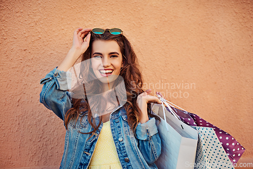 Image of Laughter and shopping is definitely the best medicine. Cropped shot of a beautiful young woman on a shopping spree in the city.