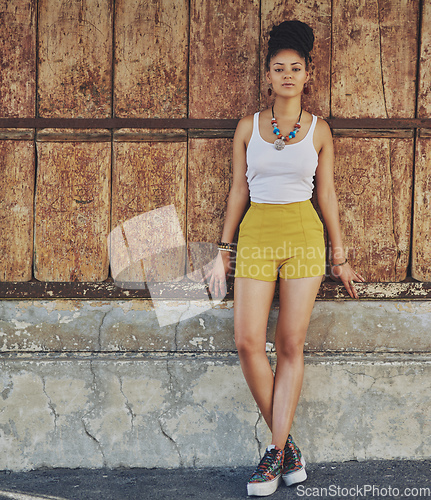 Image of Citified style. Portrait of an attractive and trendy young woman posing against an urban background.