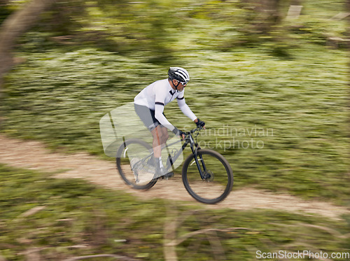 Image of Cycling, fitness and man with mountain bike in forest for speed, training or nature workout with top view off road race. Extreme sports, bicycle or cyclist in woods for workout, performance or ride