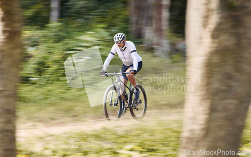 Image of Forest blur, mountain bike and sports man cycling, action and ride bicycle for cardio, fitness or transportation. Sustainable, green nature trees and cyclist training, speed and travel in woods path