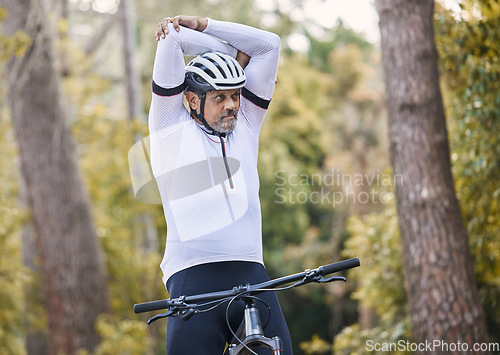 Image of Nature, cycling and sports man stretching for exercise ride, fitness and journey on outdoor mountain bike challenge. Warm up, retirement wellness and mature athlete start bicycle workout in forest