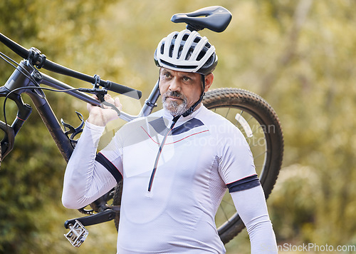 Image of Athlete, man and carrying mountain bike outdoor for cardio exercise, sports race and training in nature. Mature cyclist walking with bicycle, focus and thinking of cycling adventure on off road path