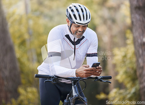 Image of Nature cycling, phone and happy man, sports athlete or bike rider check digital map, GPS location or direction. Woods, cellphone and cyclist smile for online bicycle info, forest connectivity or app