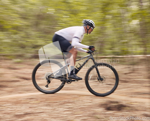 Image of Fitness, cycling and man with bicycle in a forest for speed, training or workout in nature for off road hobby. Extreme sports, mountain bike and cyclist in woods for workout or adrenaline performance