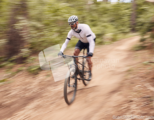 Image of Cycling, fitness and man with bicycle in a forest for speed, training or workout in nature for off road hobby. Extreme sports, mountain bike and cyclist in woods for workout or adrenaline performance
