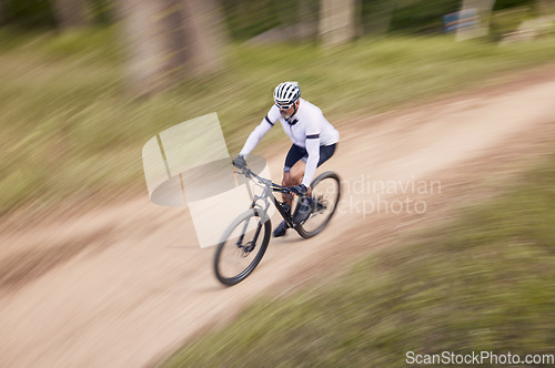 Image of Nature, mountain bike speed and sports man travel, action and ride bicycle for cycling, fitness or exercise. Top view dirt path, fast motion blur and extreme cyclist training for race on forest land
