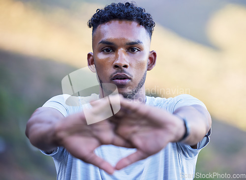 Image of Portrait, fitness and stretching with a sports man getting ready for a cardio or endurance running workout. Face, exercise and warm up with a serious young runner or athlete outdoor for training