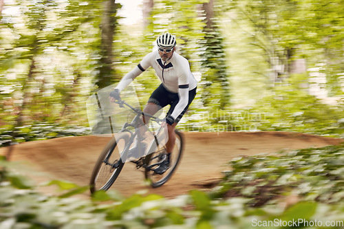 Image of Blurred trees, cycling and man in nature training for a race, marathon or competition in forest. Fast, fitness and male cyclist athlete riding bicycle at speed for cardio exercise or workout in woods