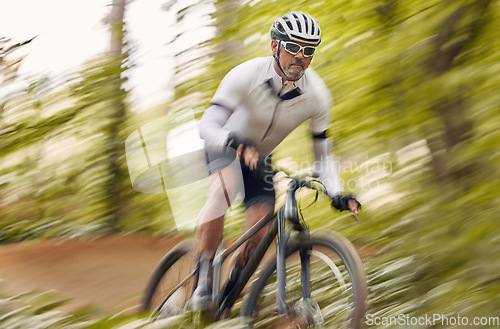 Image of Blurred nature, cycling and man athlete training for a race, marathon or competition in a forest. Fast, fitness and male cyclist riding bicycle at speed for cardio exercise or workout on a mountain.