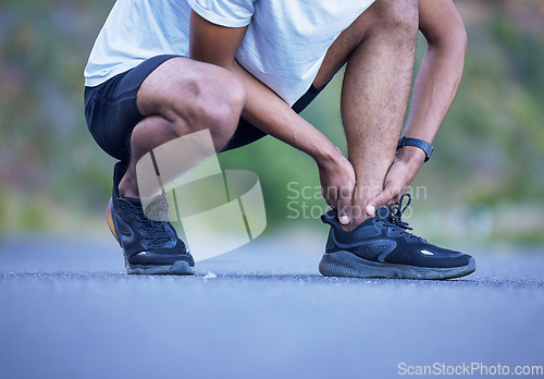 Image of Fitness, exercise and a man with ankle injury outdoor on run, workout or training. Closeup of athlete person or runner with running shoes and leg pain, hurt muscle or accident on a road for cardio