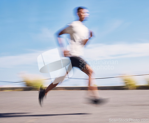 Image of Exercise, running and motion blur with a sports man on a road for his cardio or endurance workout. Fitness, health and a runner training for a marathon or challenge in the mountains during summer