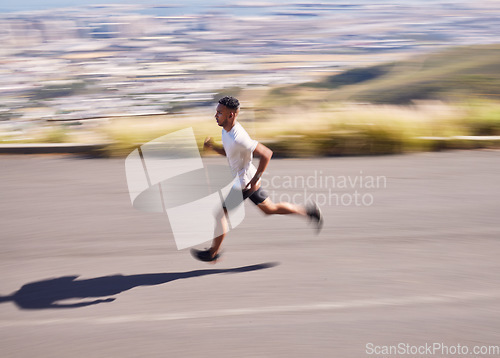 Image of Fitness, running and motion blur with a sports man on a road for his cardio or endurance workout. Exercise, health and a runner training for a marathon or challenge in the mountains during summer