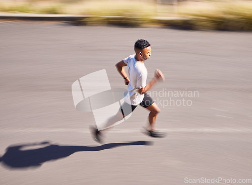 Image of Health, running and motion blur with a sports man on a road for his cardio or endurance workout from above. Exercise, fitness and a runner training for a marathon in the mountains during summer