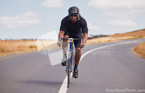 Image of Portrait, street and man on a bike for fitness, countryside cycling or training for a competition. Serious, sport and a male cyclist with a bicycle in the road for a race, adventure or nature cardio