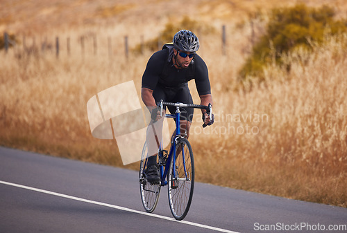 Image of Fitness, nature and bicycle, man on road for workout exercise and scenic mountain path. Health, wellness and cyclist on bike on summer morning for training, practice and cycling race in countryside.