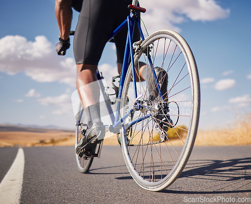 Image of Road, closeup and man on a bike for cycling, race training or travel in the countryside. Health, exercise and legs of male cyclist or athlete with a bicycle for a workout, street cardio or triathlon