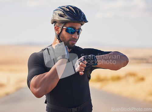 Image of Fitness, cycling and man checking pulse at race, marathon or competition training in nature. Sports, workout and young male athlete timing his heart rate for health at an outdoor cardio exercise.