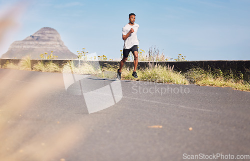 Image of Man, running and training on road in mountain, nature or outdoor exercise and athlete in healthy workout in Cape Town. Male, runner and morning cardio, sports goals or fitness challenge in summer