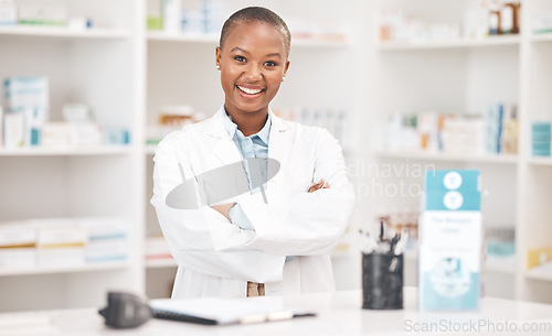Image of Crossed arms, happy and portrait of woman pharmacist working in chemist for medication dispensary. Smile, confident and African female pharmaceutical worker in medicine pharmacy for healthcare career