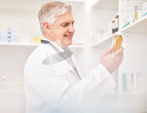 Image of Medical, product and a senior man in a pharmacy looking for prescription medicine on a shelf. Bottle, healthcare or trust with a happy pharmacist in a drugstore for chronic medication inventory