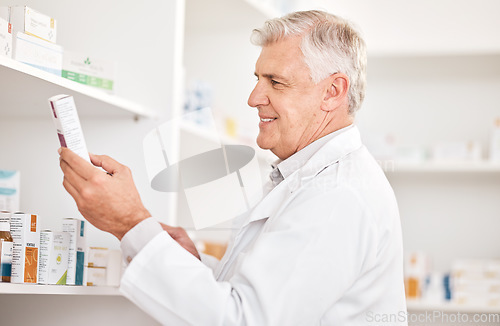 Image of Healthcare, product and a senior man in a pharmacy looking for prescription medicine on a shelf. Box, medical or trust with a happy pharmacist in a drugstore for chronic medication inventory or stock