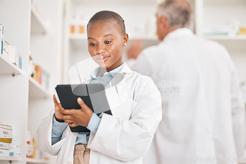 Image of Inventory, pharmacist and black woman with a tablet, healthcare and research with connection in a drugstore. Medical, pharmaceutical and African person with technology, network or check prescription