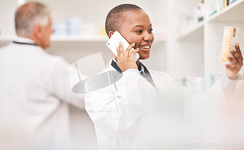 Image of Pharmacy, phone call and woman with medicine box while reading information. African person or pharmacist talking on smartphone for telehealth, consultation or customer service and product label