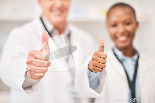 Image of Pharmacist man, woman and thumbs up in shop, retail store or hospital for feedback, review or good service. Pharmaceutical team, together and happy with icon, sign language and opinion in hospital