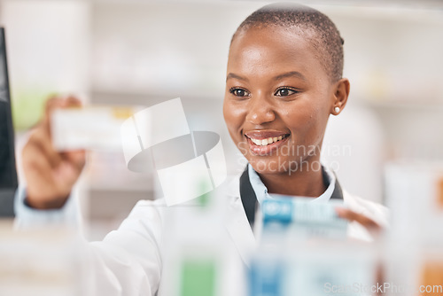 Image of Pharmacist black woman, check box and shelf with thinking, smile and product in hands, wellness or drugs. African pharmaceutical expert, package and pills in stock, inventory and retail health shop