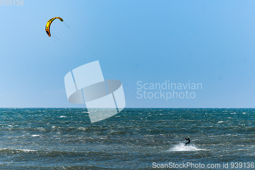 Image of Kitesurfer riding ocean waves