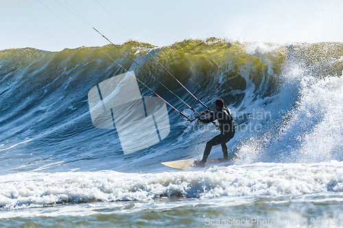 Image of Kitesurfer riding ocean waves