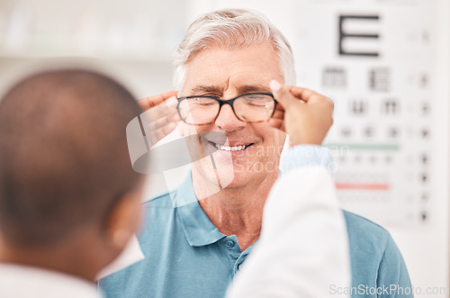 Image of Optometrist, fitting glasses and senior man with smile, test and helping hand for healthy vision in retirement. Ophthalmologist, elderly patient and exam with lens, frame and wellness for eyesight