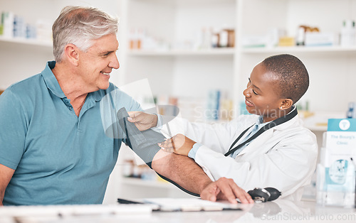 Image of Pharmacist, senior man and blood pressure check with helping hand, test and happy for healthcare in shop. Black woman, elderly patient and medical support with exam, inspection and wellness in store