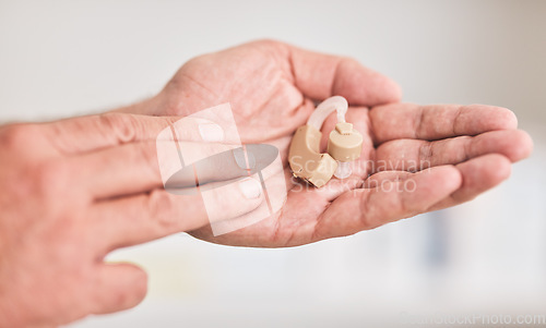 Image of Hearing aid, hands and person with disability for listening, healthcare support or medical innovation. Closeup of deaf patient with audiology implant for sound waves, amplifier or help improve volume