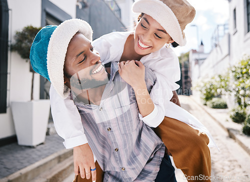 Image of Happy interracial couple, love or piggyback in city to travel on romantic date to play a fun outdoor game. Smile, eye contact or black man carrying gen z girl in silly, goofy or playful joke together